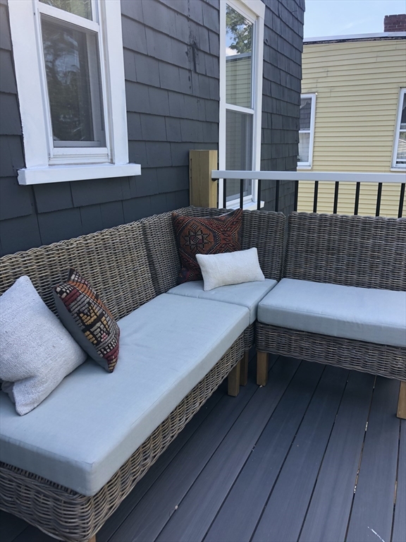 27 Armandine Street, Unit 3 Boston, MA 02124 - Photo 17 of 17 a view of a roof deck with couches and wooden floor