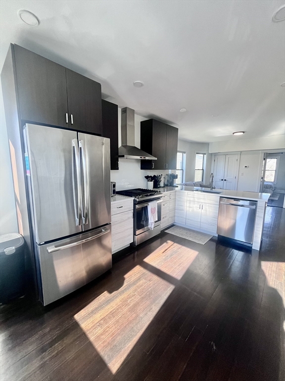 27 Armandine Street, Unit 3 Boston, MA 02124 - Photo 3 of 17 a kitchen with stainless steel appliances granite countertop a refrigerator microwave and stove