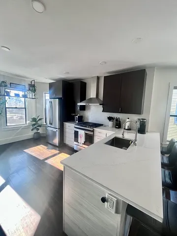 a kitchen with a sink a stove and chairs