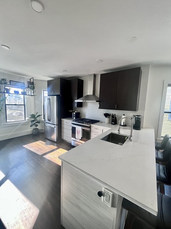 27 Armandine Street, Unit 3 Boston, MA 02124 - Photo 5 of 17 a kitchen with a sink a stove and chairs