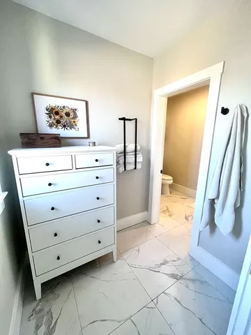 a view of a dresser in the back room