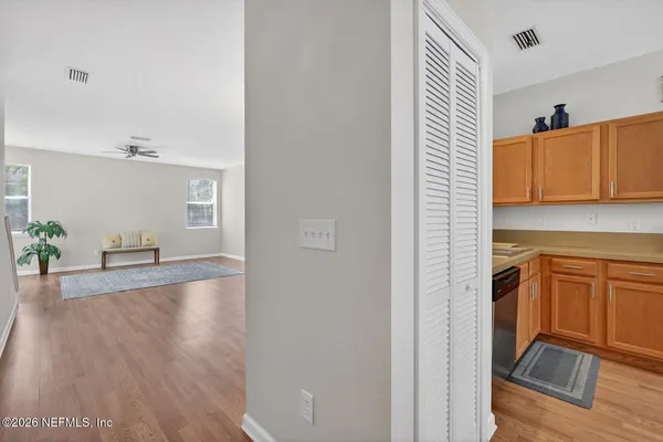 a view of a livingroom with a ceiling fan and wooden floor
