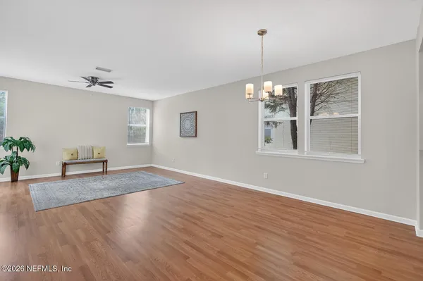 a view of a room with wooden floor and potted plant