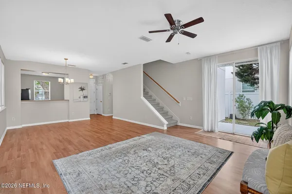 a view of a livingroom with a window and wooden floor