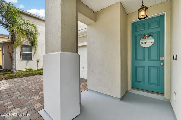 a view of a livingroom with wooden floor and a ceiling fan