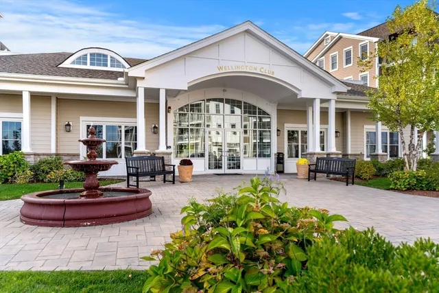 a front view of a house with a garden and plants