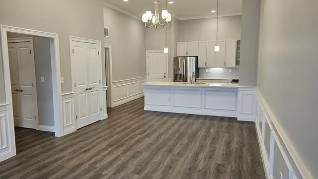 a view of a kitchen with wooden floor and a sink
