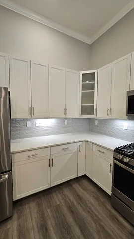 a kitchen with granite countertop cabinets stainless steel appliances and a sink
