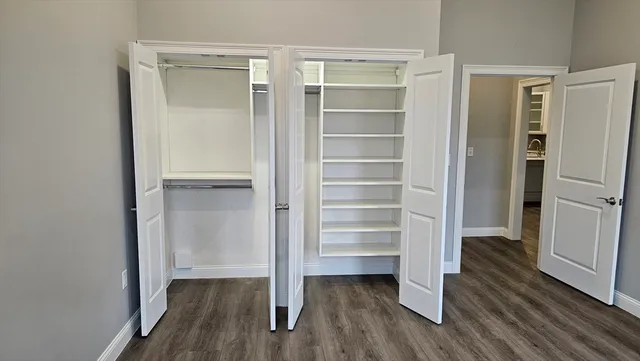 a view of walk in closet with empty racks