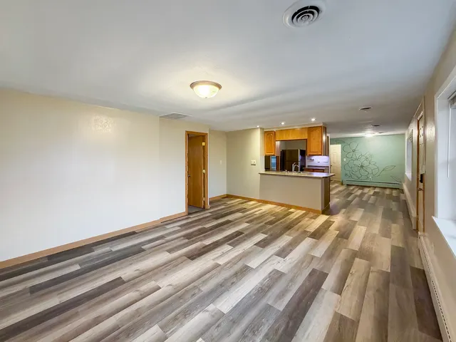 a view of a room with kitchen appliances and furniture