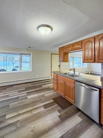 a kitchen with granite countertop a stove and a sink