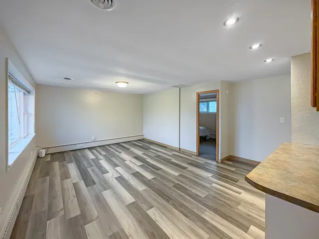 a view of a room with wooden floor and stairs
