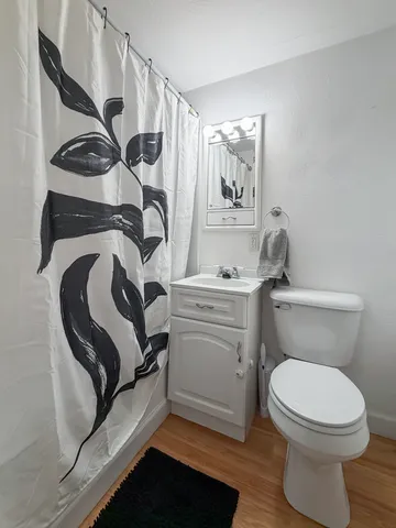 a bathroom with a toilet and a mirror