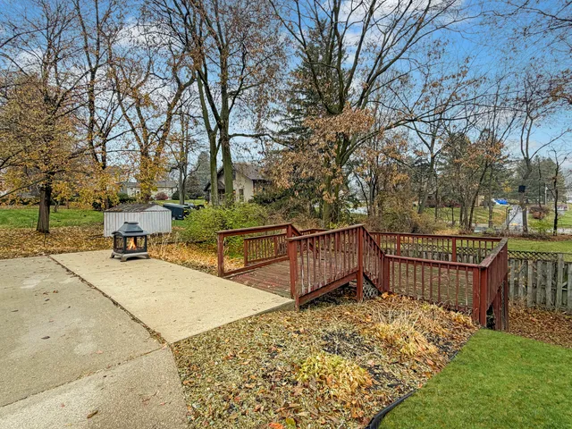 a view of a wooden deck with chairs and a yard