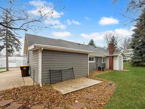 a backyard of a house with table and chairs