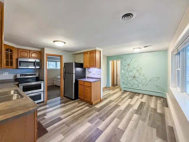 a view of kitchen with window and refrigerator