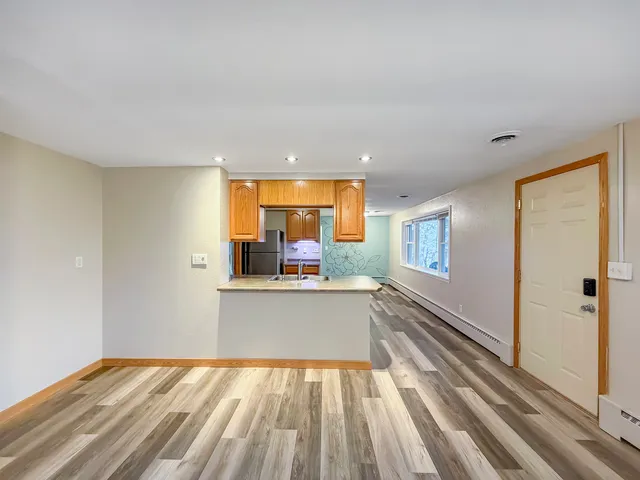 a view of a kitchen with a sink and wooden floor
