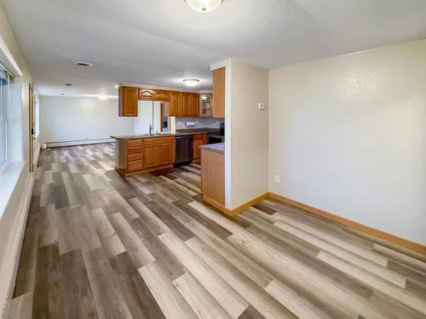 a view of kitchen with sink and refrigerator