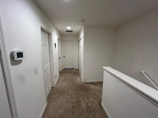 a bedroom with a bed and a potted plant