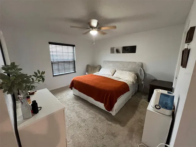 a bathroom with a granite countertop sink a toilet and a mirror