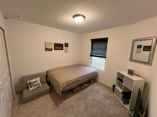 a bedroom with a bed and a desk