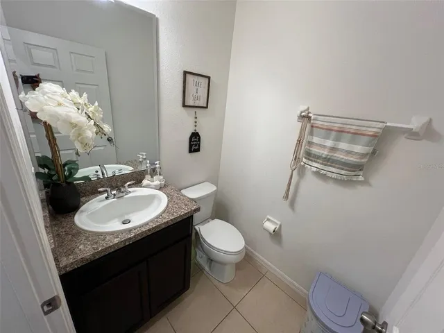 a living room with a couch and a potted plant