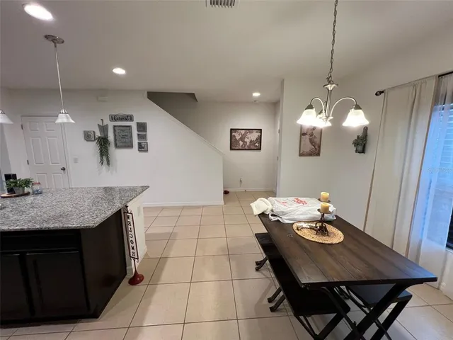 a kitchen with a table and chairs in it