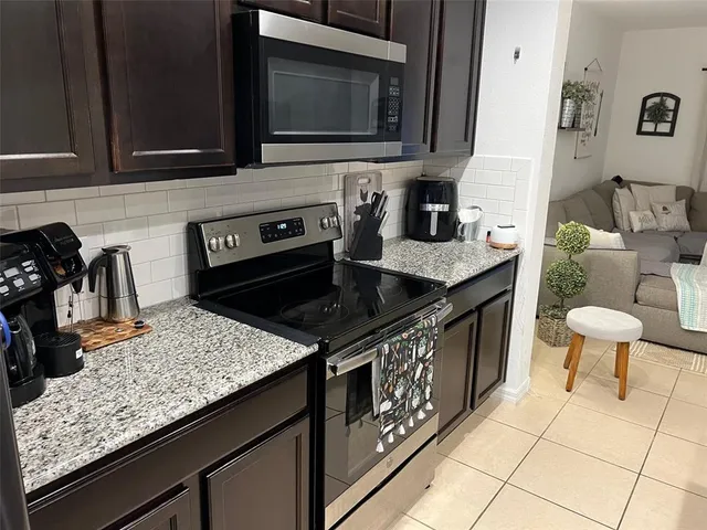 a kitchen with a stove and a microwave