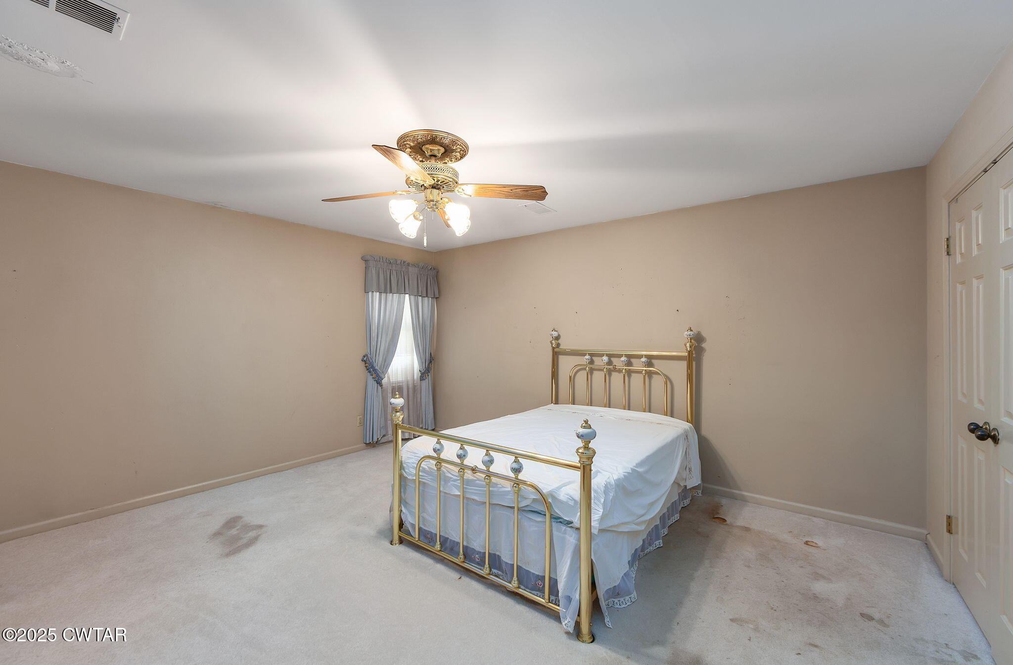 22 Bethany Drive Jackson, TN 38301 - Photo 16 of 32 a bed sitting in a bedroom next to a window