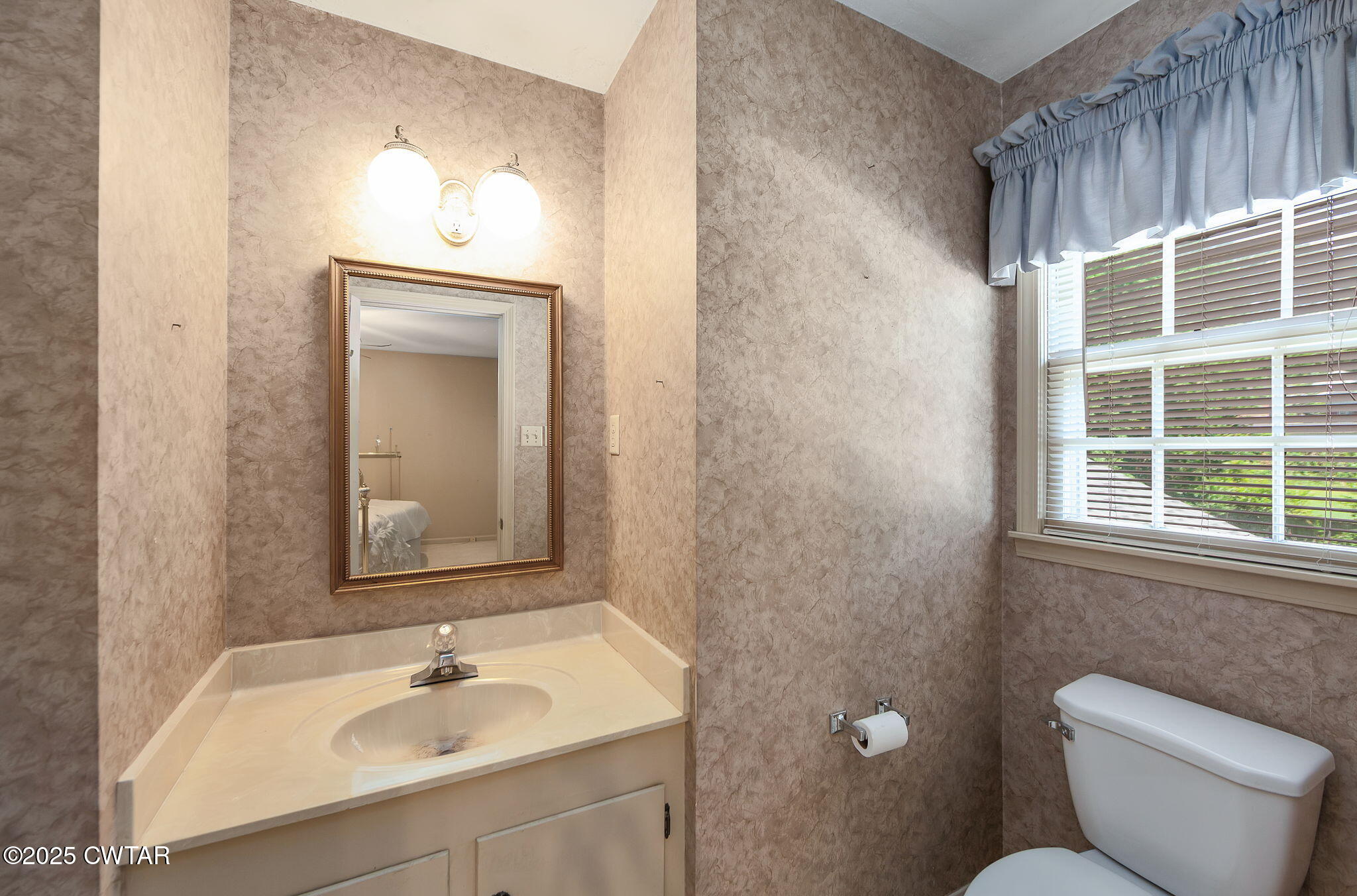 22 Bethany Drive Jackson, TN 38301 - Photo 19 of 32 a bathroom with a toilet sink vanity and mirror