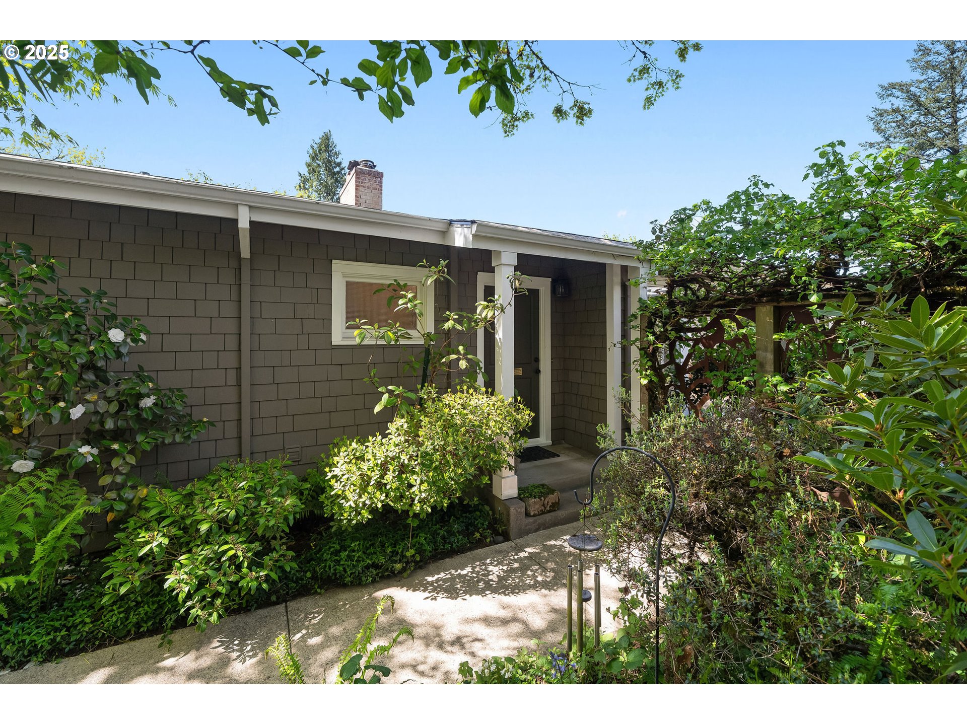 3940 Southwest Council Crest Drive Portland, OR 97239 - Photo 3 of 48 a view of a house with potted plants