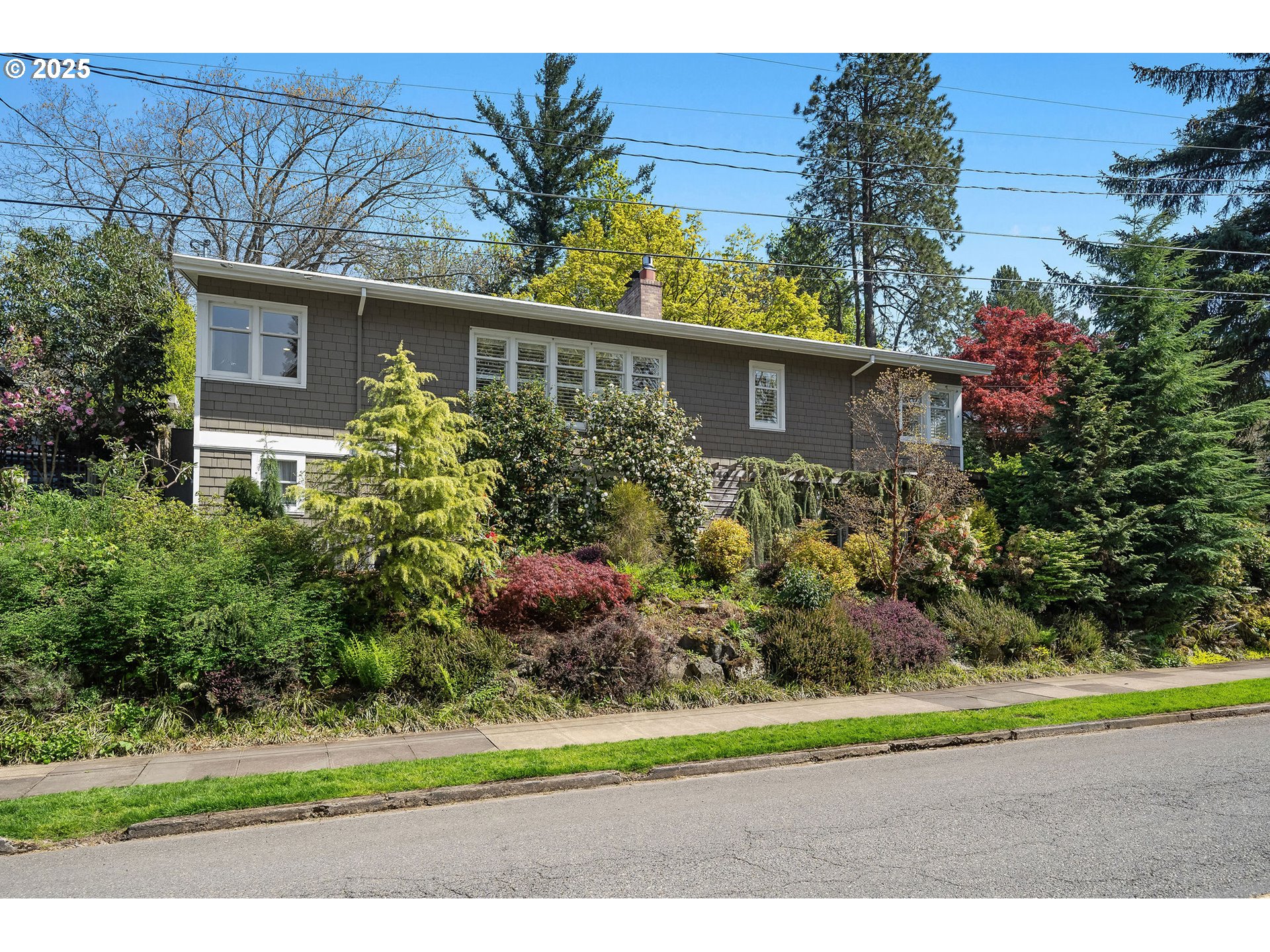 3940 Southwest Council Crest Drive Portland, OR 97239 - Photo 48 of 48 a front view of a house with a yard