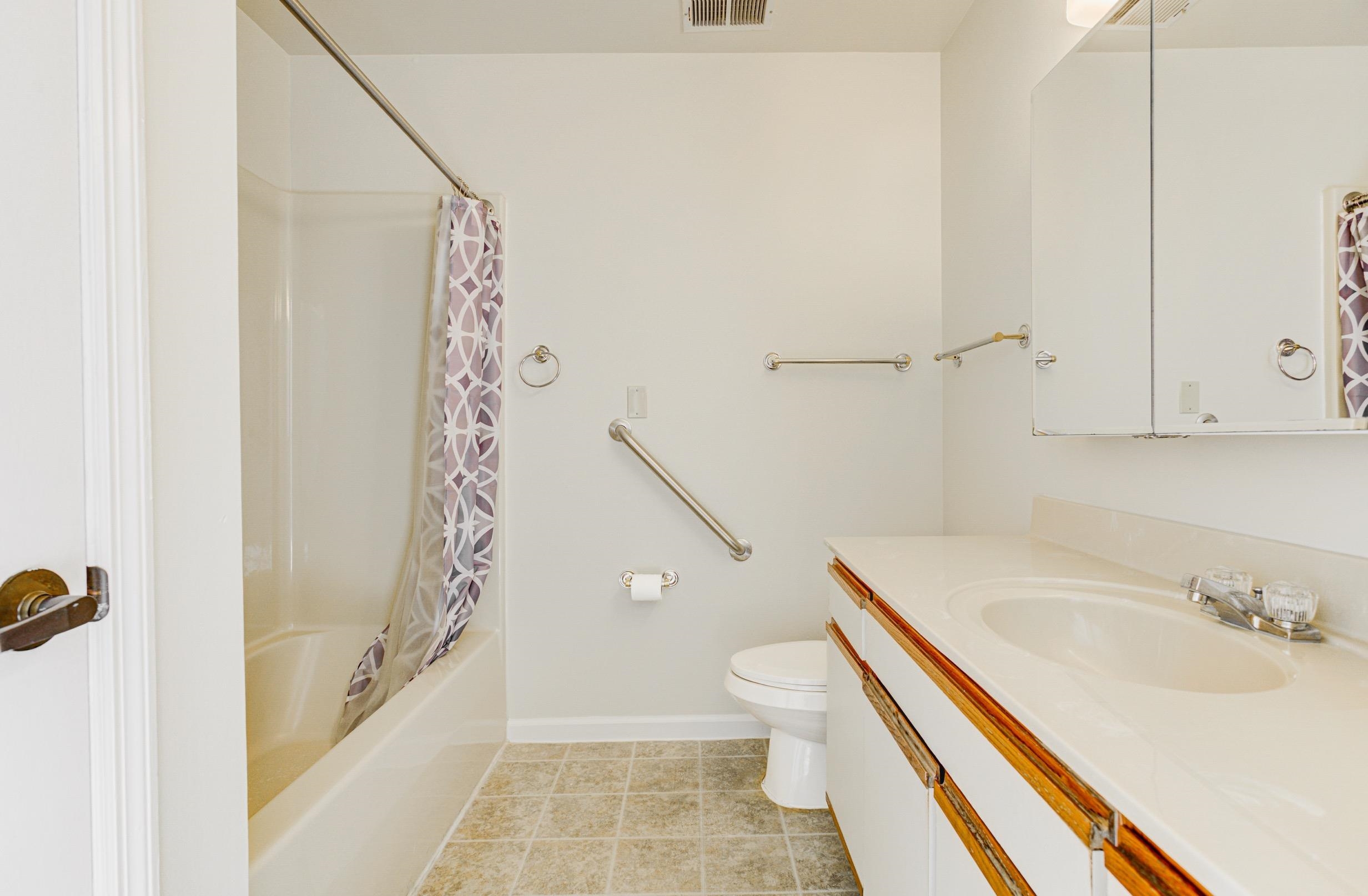 5013 Scheibler Road, Unit C1 Memphis, TN 38128 - Photo 13 of 36 a bathroom with a sink a toilet and shower
