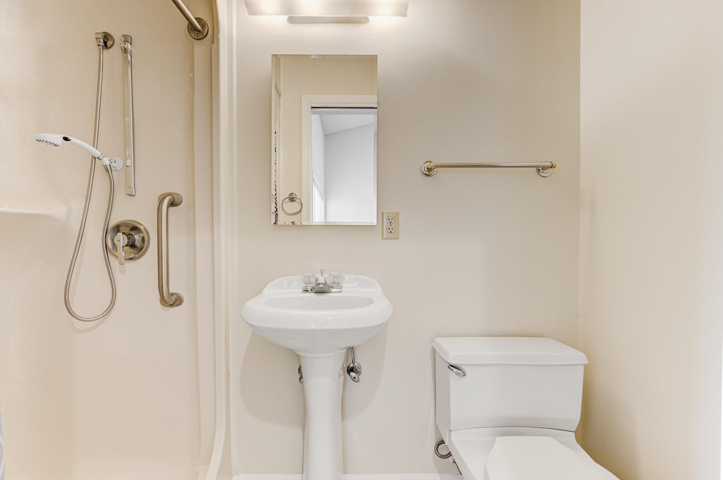 5013 Scheibler Road, Unit C1 Memphis, TN 38128 - Photo 14 of 36 a bathroom with a toilet sink and mirror