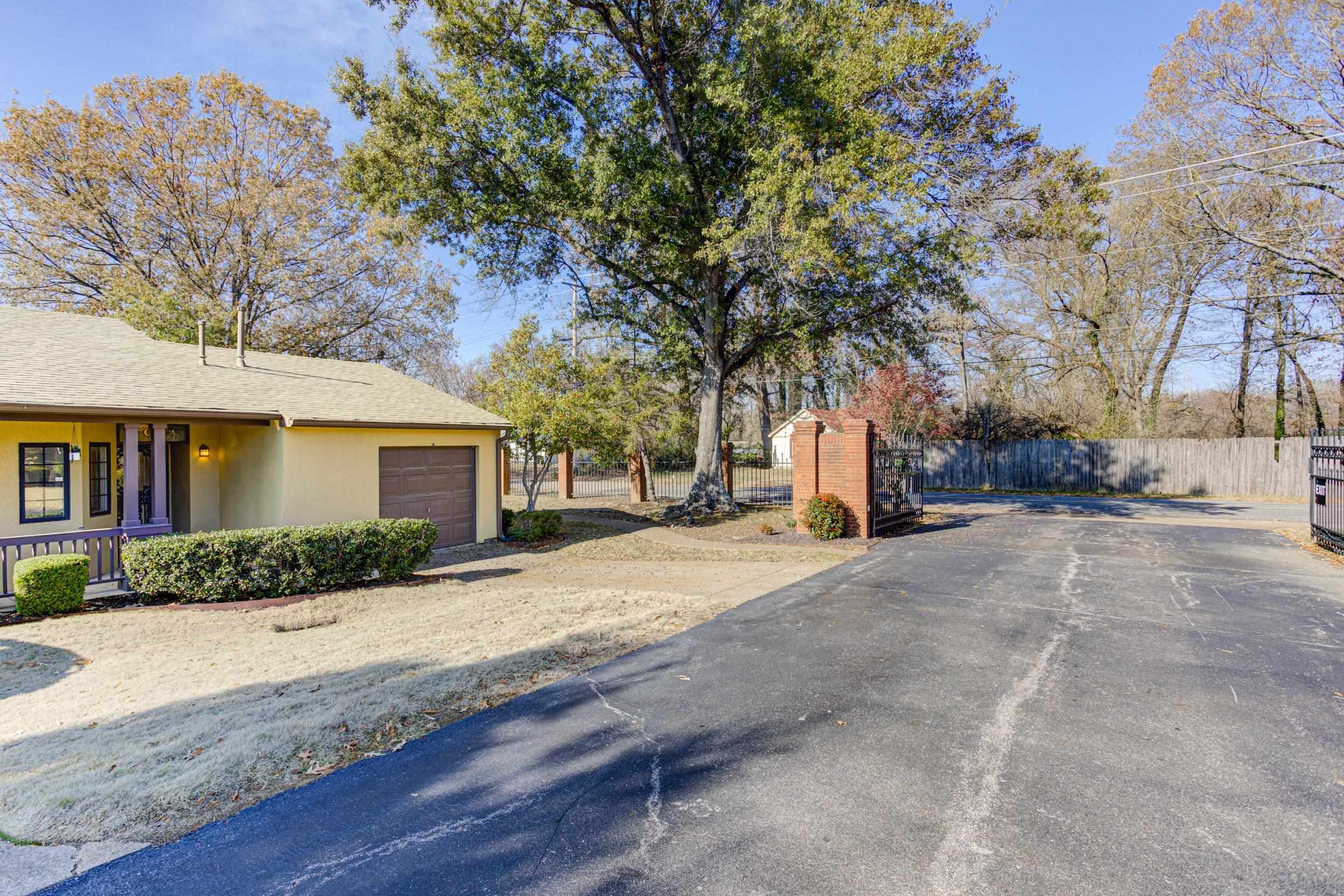 5013 Scheibler Road, Unit C1 Memphis, TN 38128 - Photo 22 of 36 a view of road with house and trees in the background