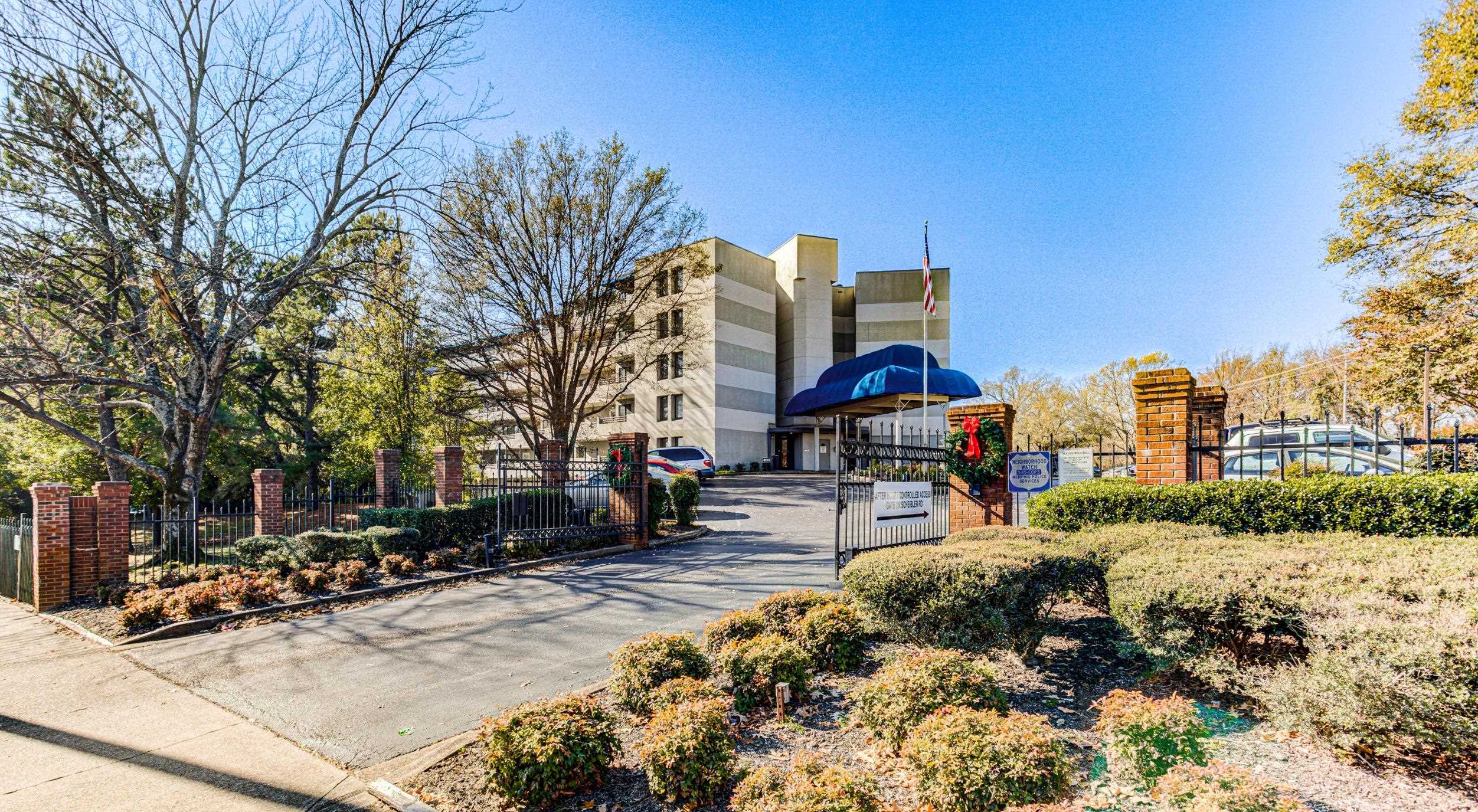 5013 Scheibler Road, Unit C1 Memphis, TN 38128 - Photo 34 of 36 a street view with tall buildings and cars parked on road