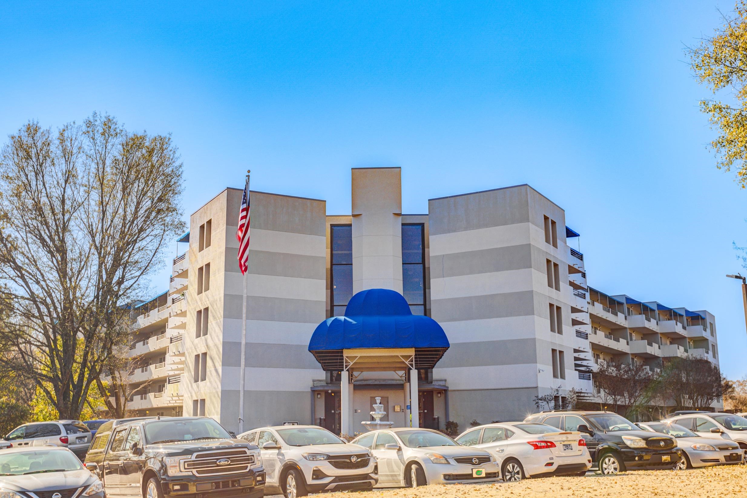 5013 Scheibler Road, Unit C1 Memphis, TN 38128 - Photo 36 of 36 a front view of a building with lot of cars and trees