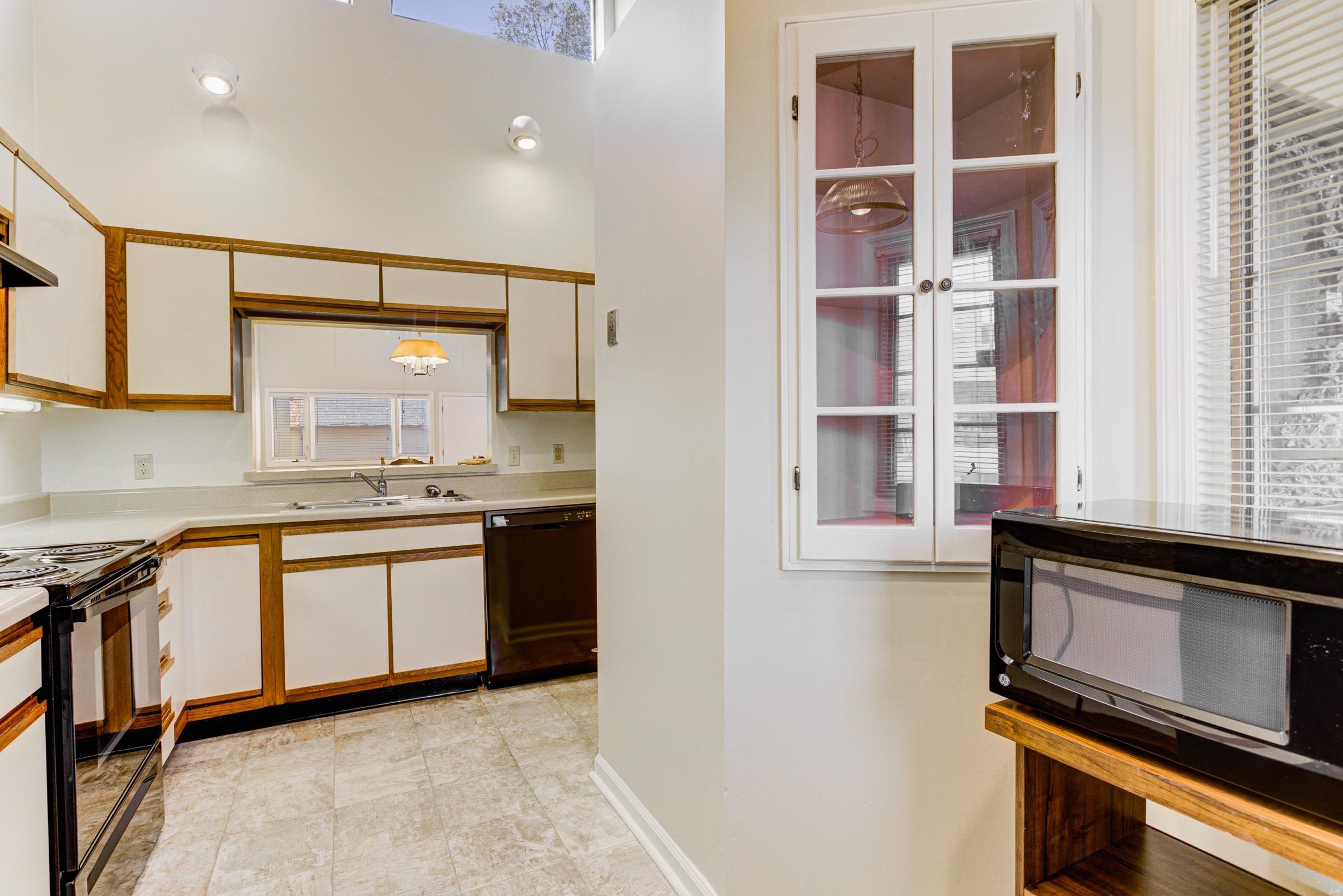 5013 Scheibler Road, Unit C1 Memphis, TN 38128 - Photo 7 of 36 a kitchen with granite countertop cabinets stainless steel appliances and a window