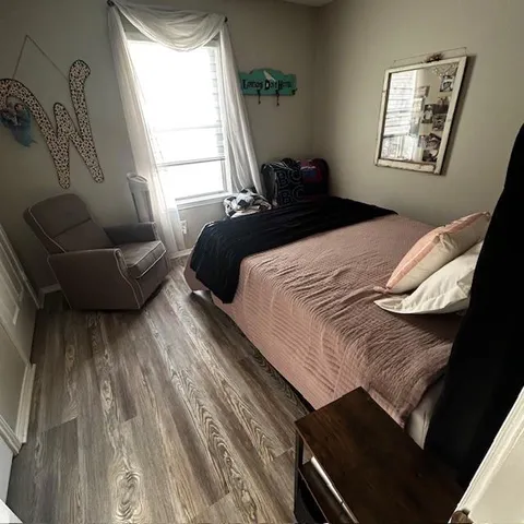a bedroom with a bed couch and a window
