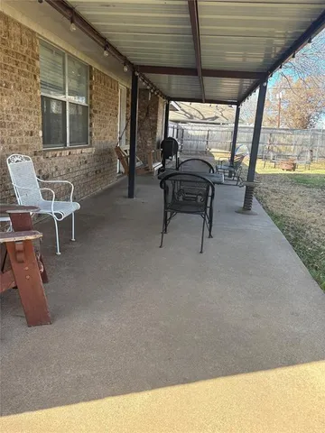 a view of a patio with table and chairs