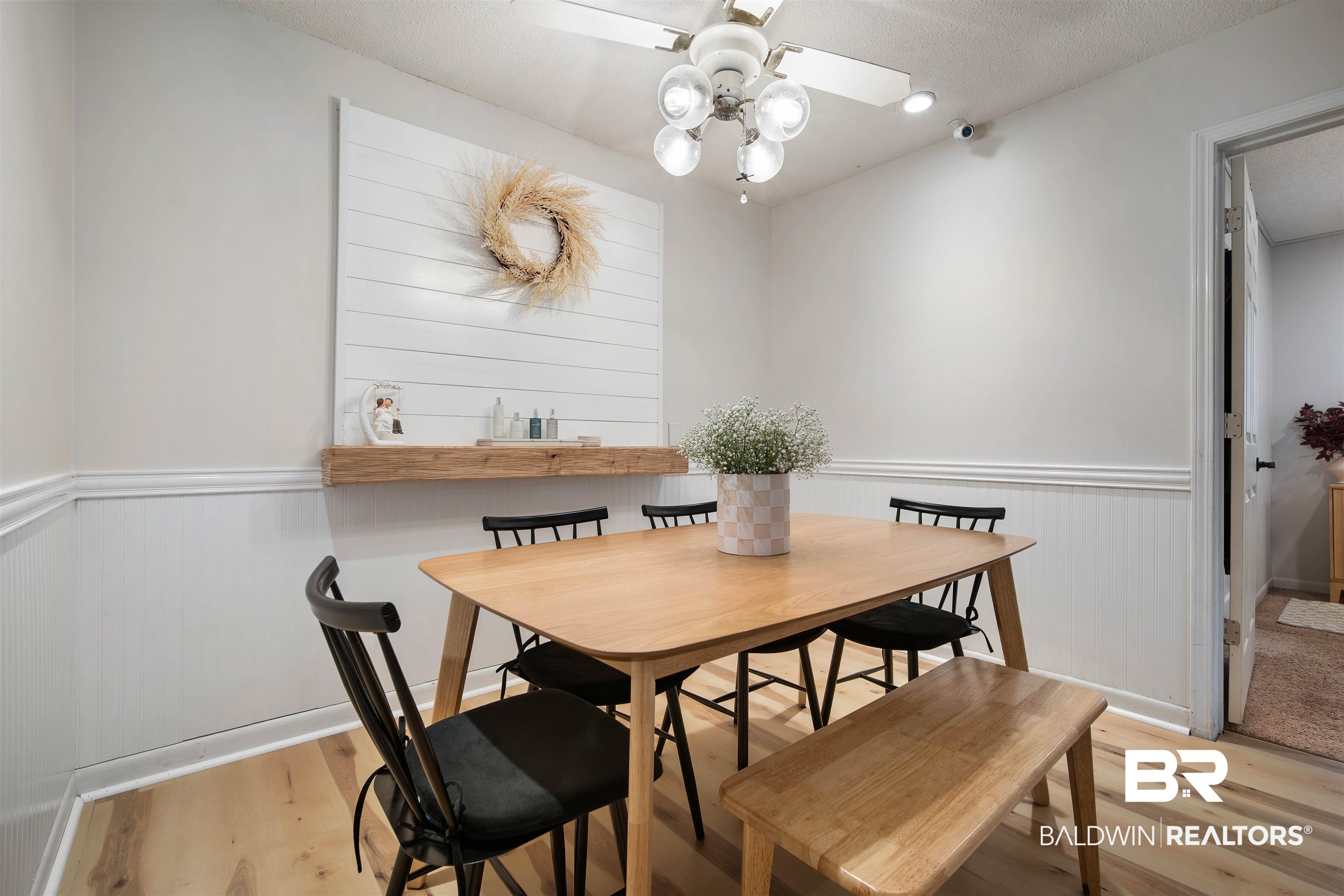 1451 West Morlee Drive Mobile, AL 36618 - Photo 12 of 30 Dining space with ceiling fan, a wainscoted wall, a textured ceiling, and light wood-style flooring