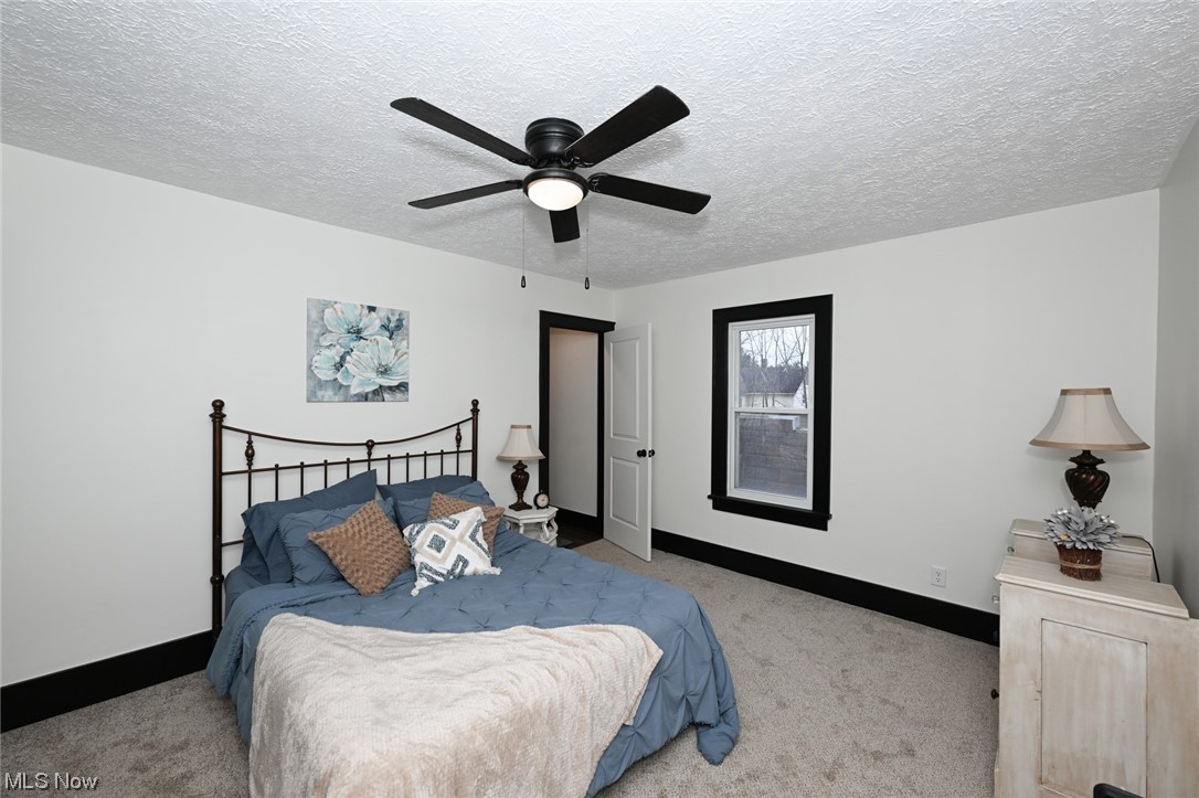 232 Randolph Road Mogadore, OH 44260 - Photo 18 of 35 Carpeted bedroom with ceiling fan and a textured ceiling