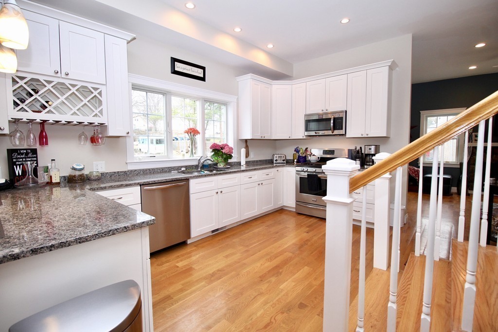 135 Argyle Road Braintree, MA 02184 - Photo 12 of 29 a kitchen with stainless steel appliances granite countertop a sink a stove top oven a counter space and cabinets
