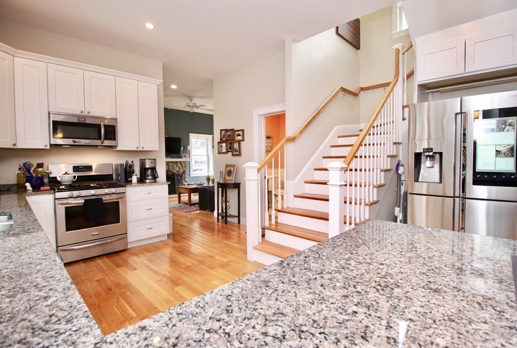 135 Argyle Road Braintree, MA 02184 - Photo 13 of 29 a kitchen with granite countertop a refrigerator and a stove top oven