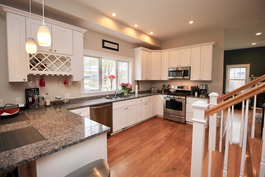 135 Argyle Road Braintree, MA 02184 - Photo 15 of 29 a kitchen with stainless steel appliances granite countertop a stove a sink and a microwave