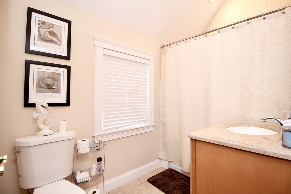 135 Argyle Road Braintree, MA 02184 - Photo 20 of 29 a bathroom with a sink a toilet and shower curtain