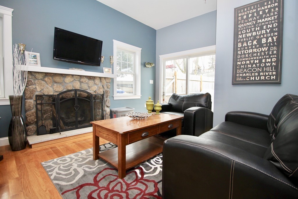 135 Argyle Road Braintree, MA 02184 - Photo 8 of 29 a living room with furniture a flat screen tv and a fireplace