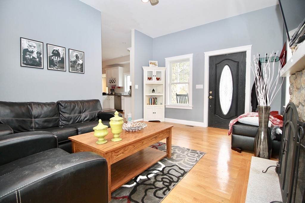 135 Argyle Road Braintree, MA 02184 - Photo 9 of 29 a living room with furniture and a fireplace