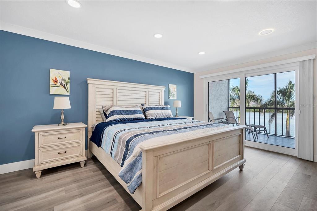 9393 Midnight Pass Road, Unit 302 Sarasota, FL 34242 - Photo 15 of 65 a spacious bedroom with a bed and a large window