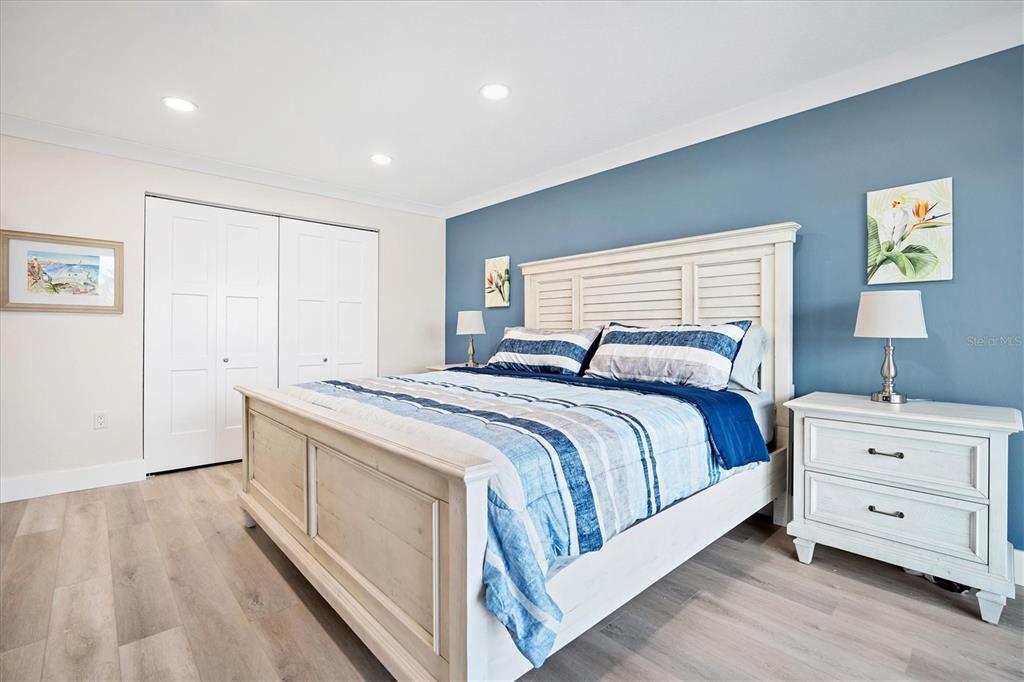 9393 Midnight Pass Road, Unit 302 Sarasota, FL 34242 - Photo 17 of 65 a spacious bedroom with a bed and a couch